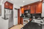 This stunning kitchen boasts rich wood cabinetry, offering ample storage and a warm, inviting atmosphere.