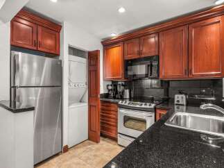 This stunning kitchen boasts rich wood cabinetry, offering ample storage and a warm, inviting atmosphere.