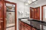 This stunning bathroom features a sleek granite countertop and a modern sink, perfect for a luxurious experience.