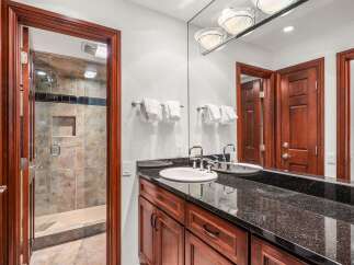 This stunning bathroom features a sleek granite countertop and a modern sink, perfect for a luxurious experience.