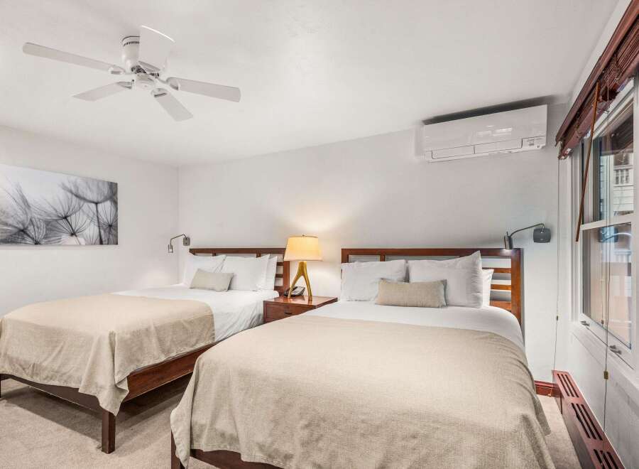This inviting bedroom features two comfortable beds, perfect for guests or roommates.