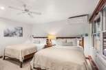 This inviting bedroom features two comfortable beds, perfect for guests or roommates.