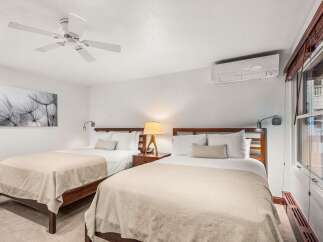 This inviting bedroom features two comfortable beds, perfect for guests or roommates.