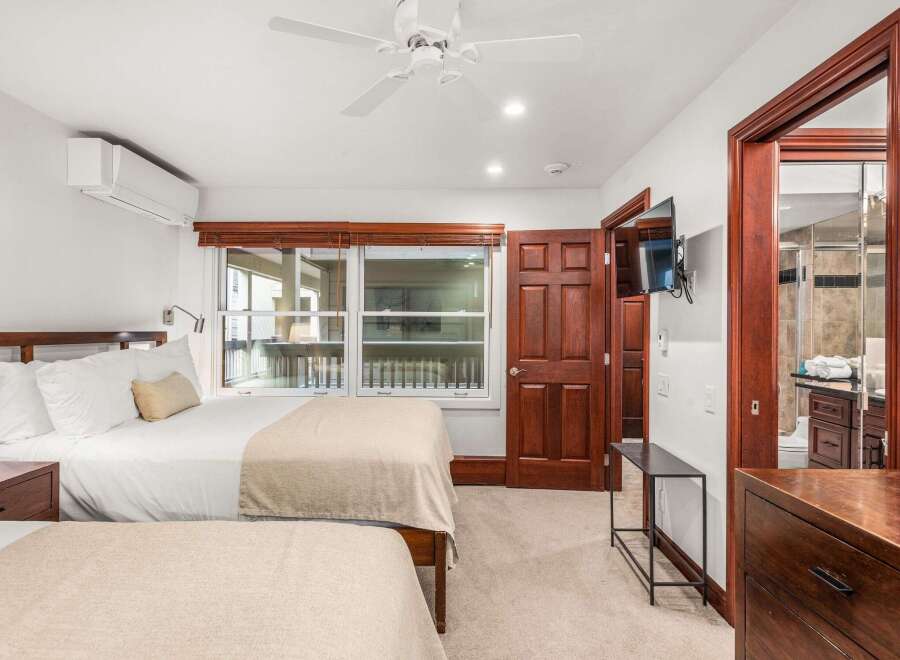 Step into this inviting bedroom, featuring two comfortable beds perfect for a relaxing stay.