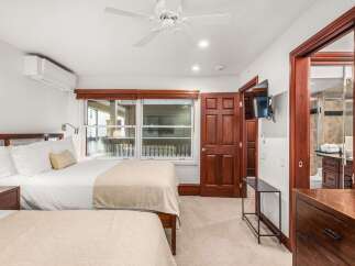 Step into this inviting bedroom, featuring two comfortable beds perfect for a relaxing stay.