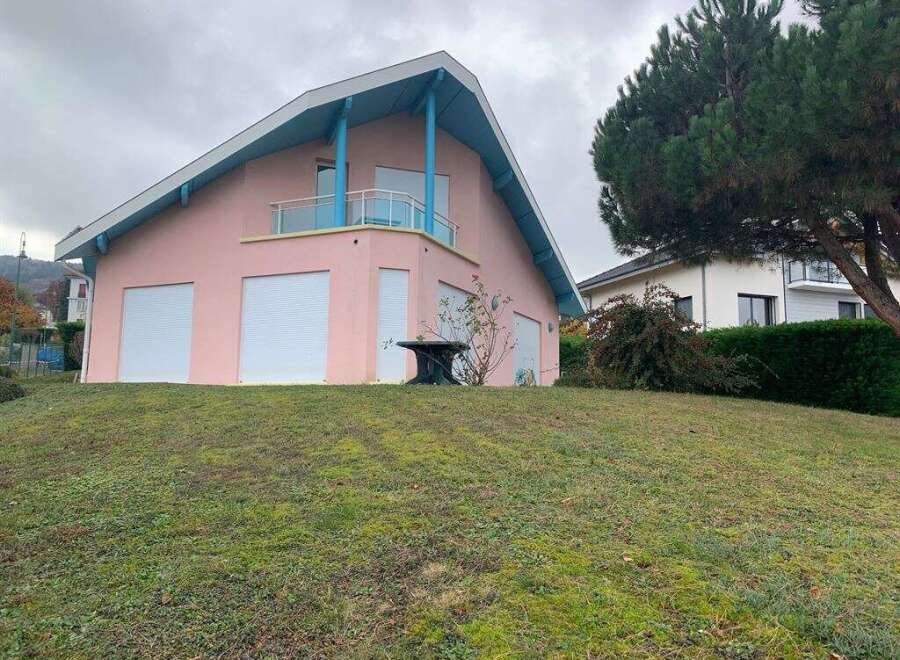 Discover this charming pink house with a unique architectural design.