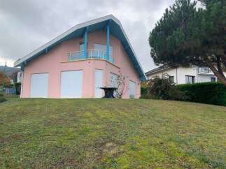Discover this charming pink house with a unique architectural design.