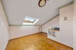 Discover this charming attic space, featuring a unique skylight that floods the room with natural light.