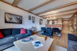 Experience luxury living in this stunning property, featuring a cozy living room with a comfortable sofa and a stylish coffee table.