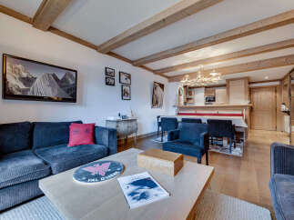 Experience luxury living in this stunning property, featuring a cozy living room with a comfortable sofa and a stylish coffee table.