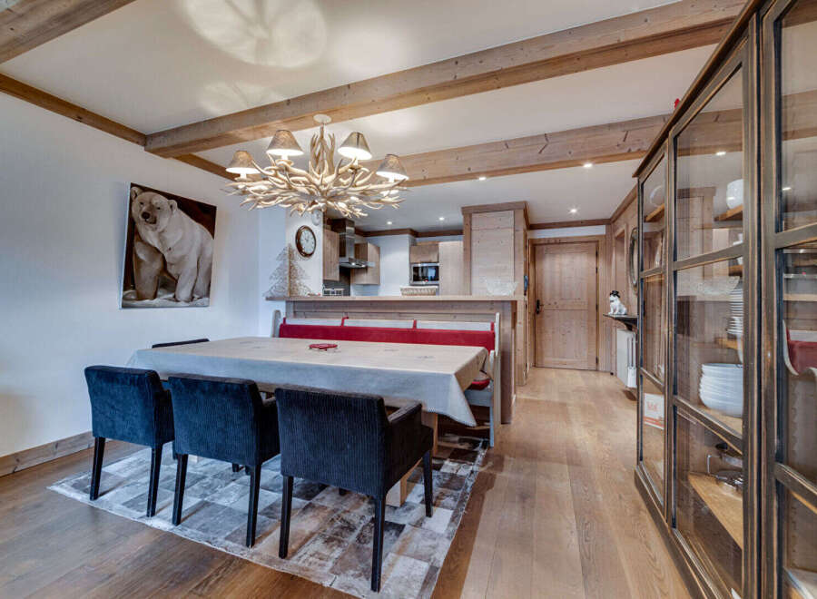 Step into this charming property featuring a cozy dining area with a rustic wooden table and stylish chairs.
