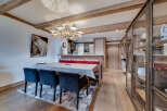 Step into this charming property featuring a cozy dining area with a rustic wooden table and stylish chairs.