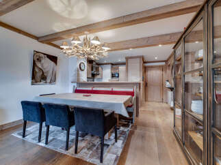 Step into this charming property featuring a cozy dining area with a rustic wooden table and stylish chairs.