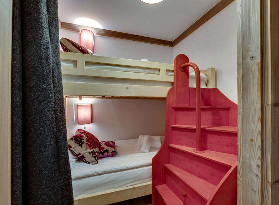 Discover the charm of this cozy bunk bed room, perfect for a vacation home or a kid's room.