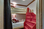 Discover the charm of this cozy bunk bed room, perfect for a vacation home or a kid's room.