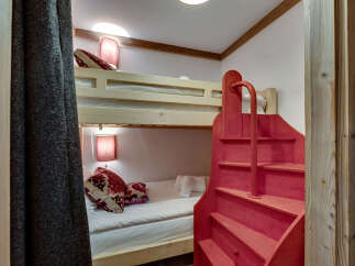 Discover the charm of this cozy bunk bed room, perfect for a vacation home or a kid's room.