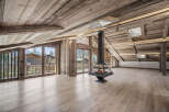 Experience luxury living in this stunning chalet, featuring a unique fireplace and expansive windows that frame breathtaking mountain views.