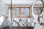 Experience luxury in this stunning bathroom featuring exquisite marble detailing and a serene view.