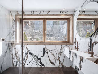 Experience luxury in this stunning bathroom featuring exquisite marble detailing and a serene view.