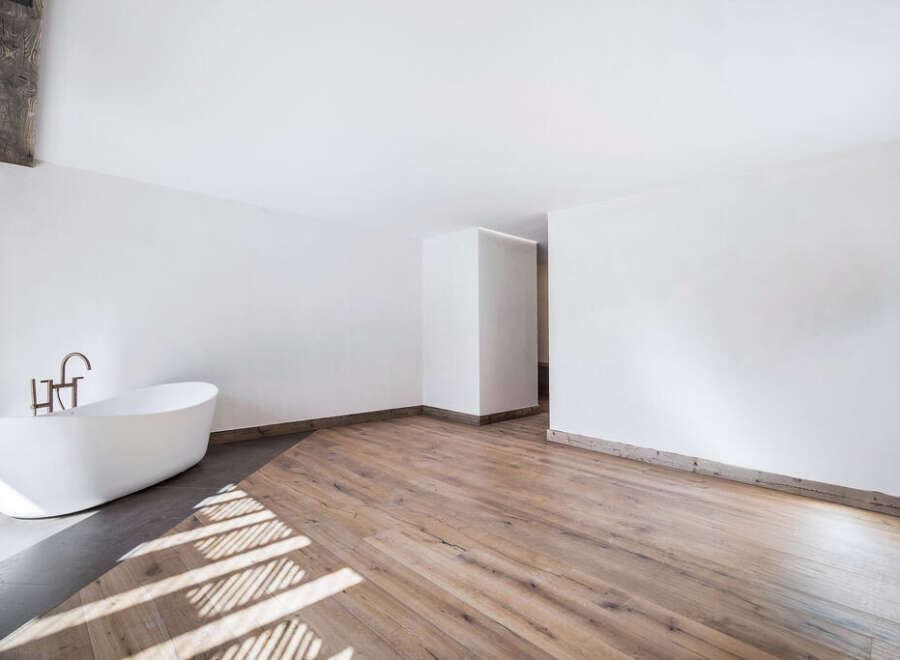 This stunning bathroom boasts a modern design with a luxurious freestanding bathtub, perfect for relaxation.