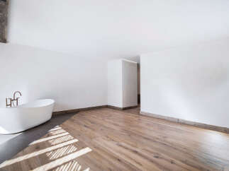 This stunning bathroom boasts a modern design with a luxurious freestanding bathtub, perfect for relaxation.
