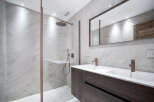 Step into luxury with this stunning bathroom featuring a sleek, modern design.