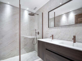 Step into luxury with this stunning bathroom featuring a sleek, modern design.