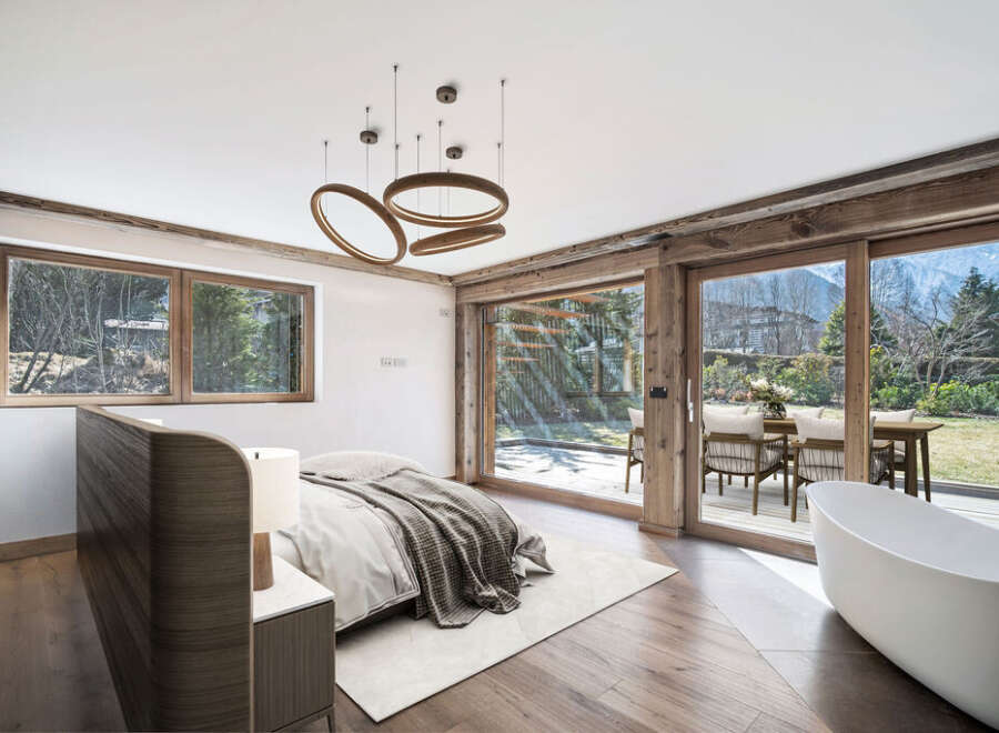 Experience luxury living in this stunning bedroom with breathtaking mountain views.