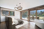 Experience luxury living in this stunning bedroom with breathtaking mountain views.