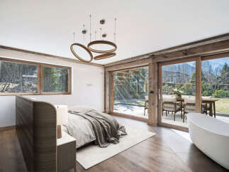 Experience luxury living in this stunning bedroom with breathtaking mountain views.
