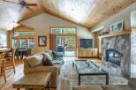 Step into luxury with this stunning living room, featuring a cozy fireplace and a stylish entertainment center.