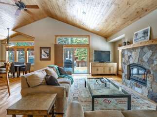 Step into luxury with this stunning living room, featuring a cozy fireplace and a stylish entertainment center.