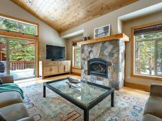 Step into luxury with this stunning living room featuring a cozy fireplace and a sleek TV setup.