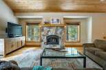 Experience the warmth of this stunning living room, featuring a cozy fireplace and a stylish coffee table.