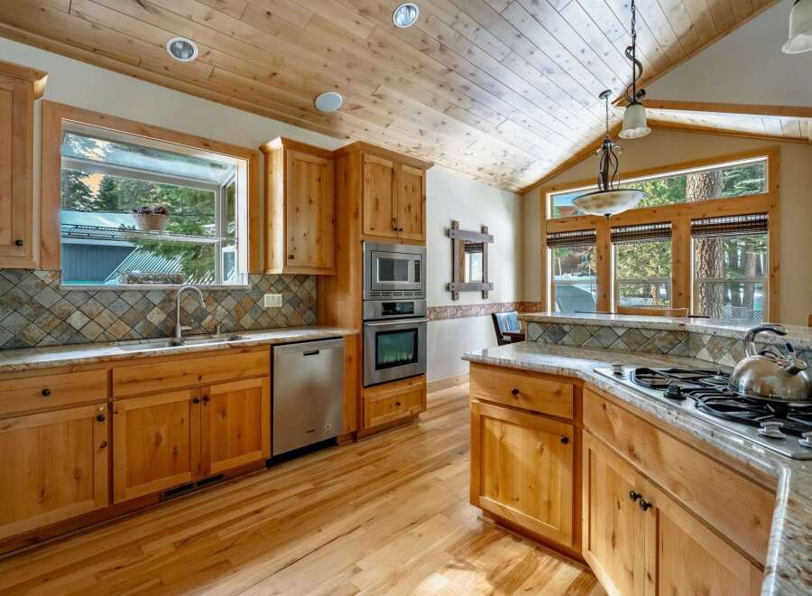 Step into this stunning kitchen, boasting beautiful wooden cabinetry and a warm, inviting atmosphere.