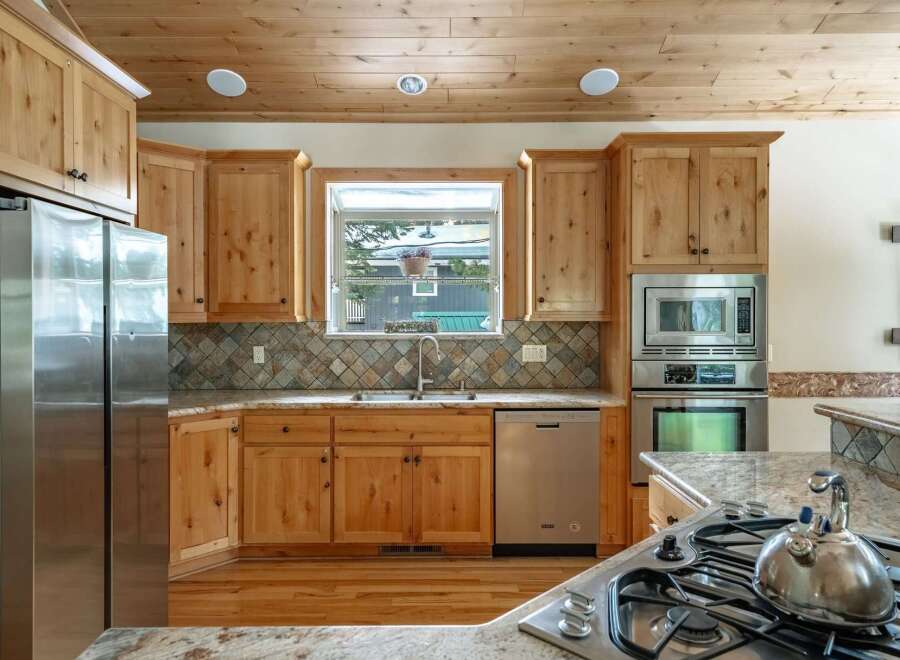 This stunning kitchen boasts beautiful wooden cabinetry, offering ample storage and a warm, inviting atmosphere.