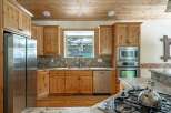 This stunning kitchen boasts beautiful wooden cabinetry, offering ample storage and a warm, inviting atmosphere.