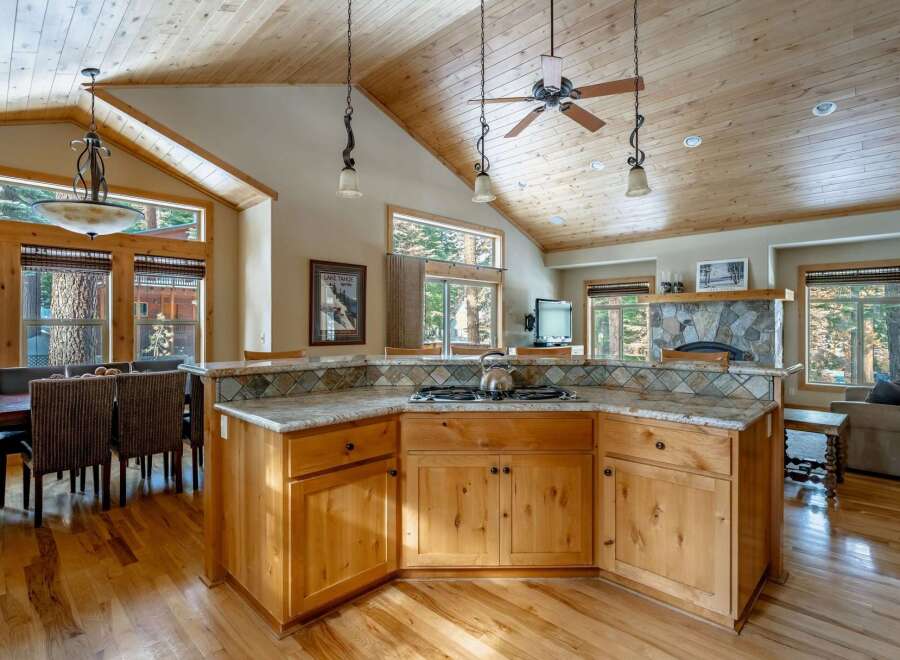 This stunning kitchen boasts a warm and inviting atmosphere with its wooden cabinetry and flooring.
