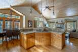 This stunning kitchen boasts a warm and inviting atmosphere with its wooden cabinetry and flooring.