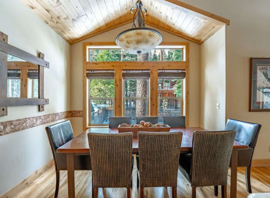 This stunning dining room features a rustic wooden table and chairs, perfect for hosting family gatherings.