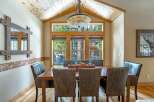 This stunning dining room features a rustic wooden table and chairs, perfect for hosting family gatherings.