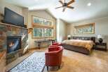This stunning bedroom features a cozy fireplace with a mounted TV, perfect for relaxing evenings.
