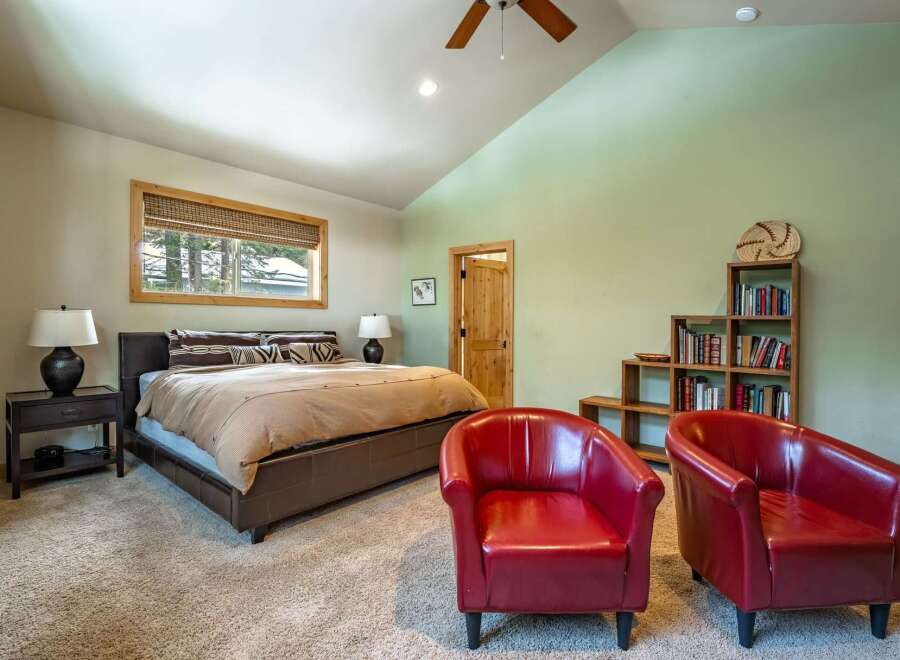 This inviting bedroom boasts a cozy atmosphere with its plush carpet and warm color palette.