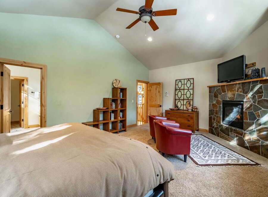 This stunning bedroom boasts a cozy fireplace, perfect for those chilly evenings.