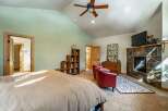 This stunning bedroom boasts a cozy fireplace, perfect for those chilly evenings.
