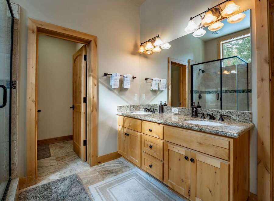 This stunning bathroom boasts a luxurious vanity with granite countertops and ample storage.