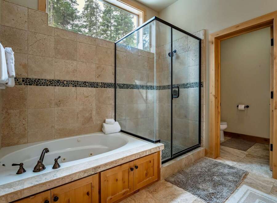 This luxurious bathroom boasts a spa-like ambiance with its elegant design and high-end features.