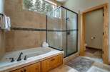 This luxurious bathroom boasts a spa-like ambiance with its elegant design and high-end features.