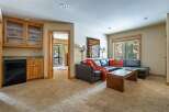 This stunning property features a cozy living area with a comfortable sectional sofa and a warm, inviting atmosphere.