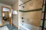 Step into luxury with this stunning bathroom featuring elegant tile work and a relaxing bathtub.